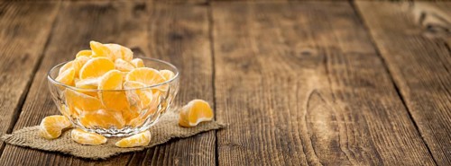 Fresh Tangerine pieces (selective focus) on a vintage background