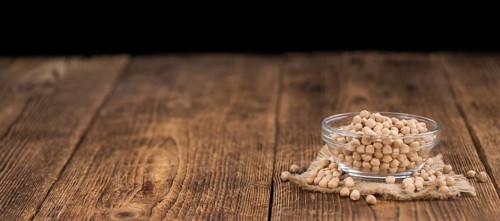 Chickpeas on an old wooden table as detailed close-up shot, selective focus