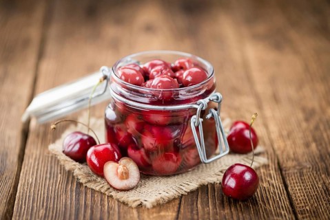 Preserved Cherries on a vintage background as detailed close-up shot, selective focus