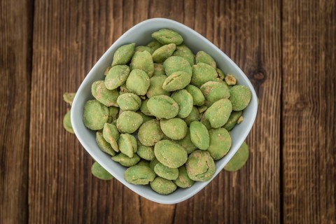 Wasabi Peanuts on a vintage background as detailed close-up shot (selective focus)