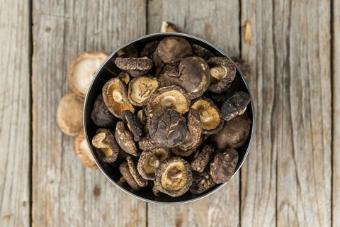 Dried Shiitake on a vintage background as detailed close-up shot, selective focus
