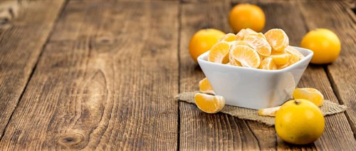 Raw Tangerine pieces (close-up shot) on vintage background