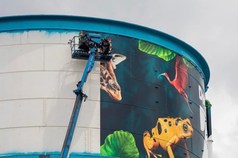 Detroit, Michigan, Workers wrap a new design on the water tower at the Detroit Zoo