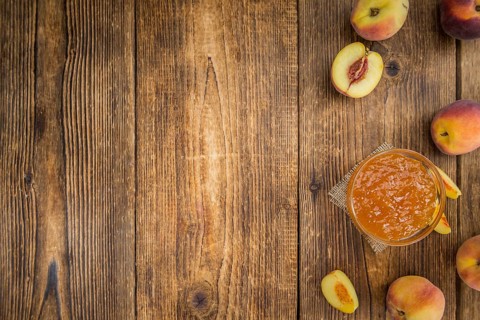 Portion of fresh Peach Jam close-up shot, selective focus