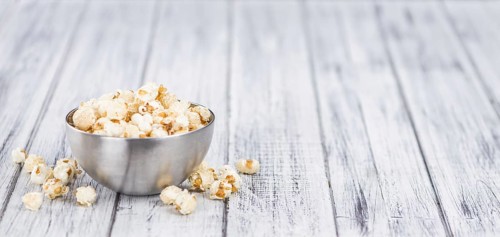 Fresh made Popcorn on an old and rustic wooden table, selective focus, close-up shot