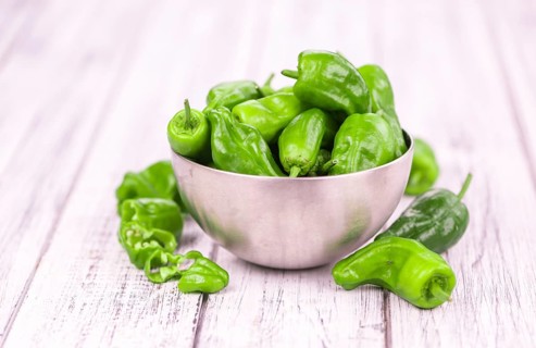 Raw Pimientos on a vintage background as detailed close-up shot, selective focus
