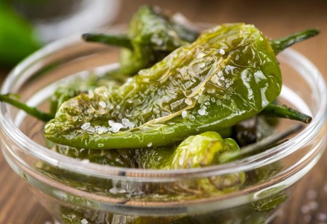 Pimientos de Padron on a vintage background as detailed close-up shot, selective focus