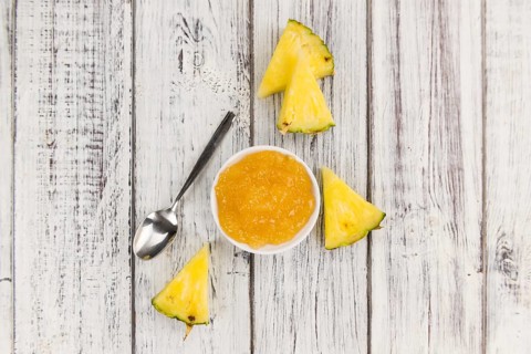Fresh made Pineapple Jam on an old and rustic wooden table, selective focus, close-up shot
