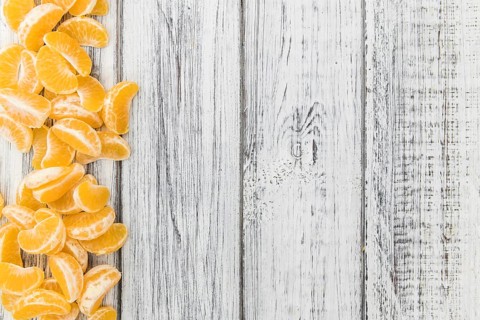 Fresh Tangerine pieces (selective focus) on a vintage background