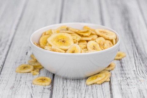 Portion of fresh Dried Banana Chips close-up shot, selective focus