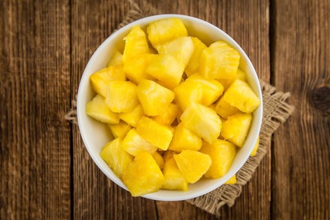 Fresh made Pineapple (sliced) on a vintage background as detailed close-up shot