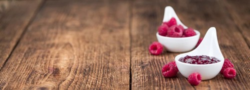 Fresh made Raspberry Jam on a vintage background as detailed close-up shot