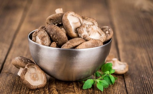 Portion of fresh Shiitake mushrooms close-up shot, selective focus