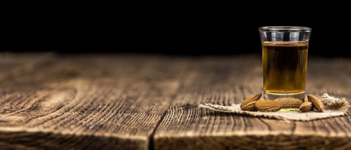 Amaretto on an old wooden table (selective focus)