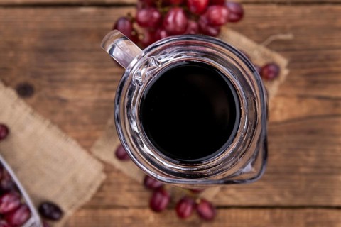 Some fresh Red Grape Juice (selective focus, close-up shot)