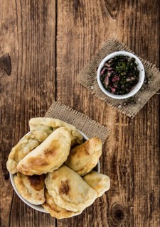 Portion of fresh homemade Empanadas as detailed close-up shot, selective focus