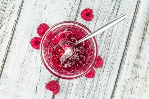 Fresh made Raspberry Jam on a vintage background as detailed close-up shot