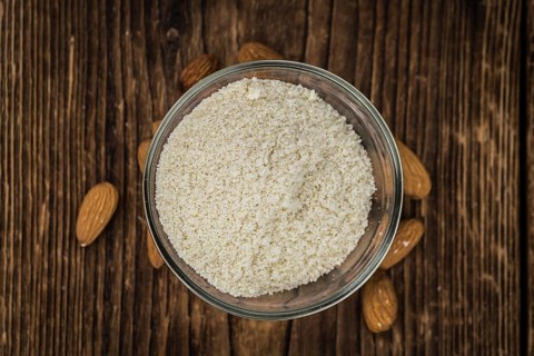 Wooden table with Almond Flour (detailed close-up shot, selective focus)