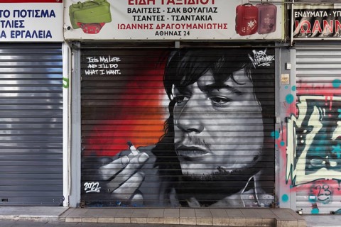 Portrait of a stoner with a joint on a shutter, I do what I want, cannabis, graffiti by street