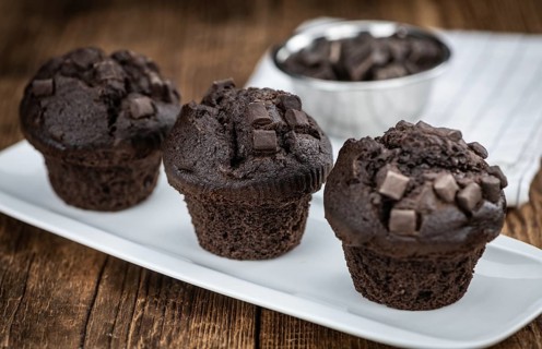 Vintage wooden table with Chocolate Muffins (selective focus, close-up shot)