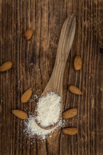 Portion of fresh Powdered Almonds on an old wooden table