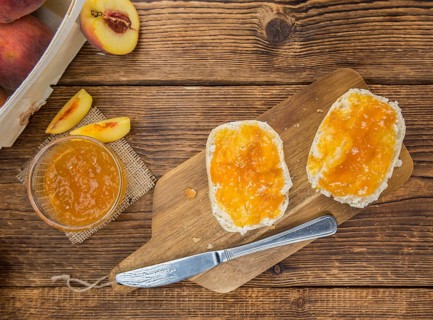 Portion of fresh Peach Jam close-up shot, selective focus