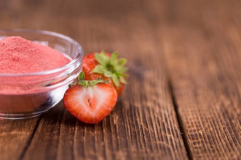 Fresh made Strawberry powder on a vintage background as detailed close-up shot