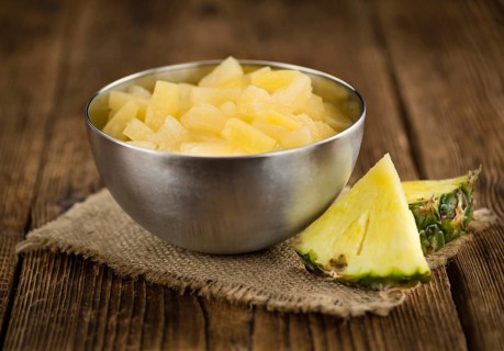 Preserved Pineapple pieces on a vintage background as detailed close-up shot, selective focus