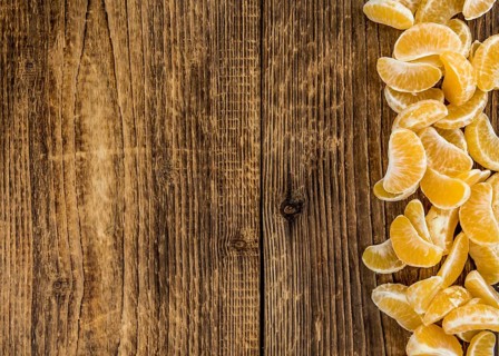 Fresh Tangerine pieces (selective focus) on a vintage background