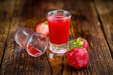Homemade Strawberry liqueur on vintage background selective focus, close-up shot