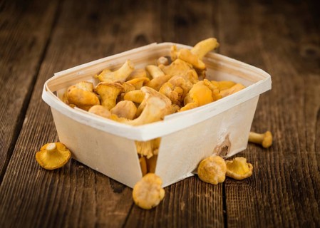 Chanterelles as high detailed close-up shot on a vintage wooden table, selective focus