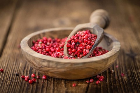 Pink Peppercorns on a vintage background as detailed close-up shot, selective focus
