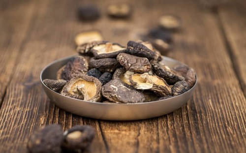 Homemade Dried Shiitake on an wooden table as detailed close-up shot, selective focus