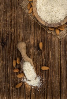 Portion of fresh Powdered Almonds on an old wooden table