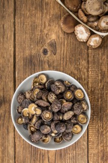 Dried Shiitake on a vintage background as detailed close-up shot, selective focus