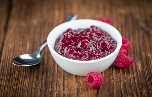 Some homemade Raspberry Jam as detailed close-up shot, selective focus
