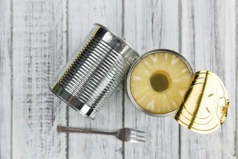 Fresh made Preserved Pineapple Rings on a vintage background as detailed close-up shot