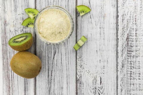 Fresh made Kiwi powder (slective focus, close-up shot) on an old wooden table