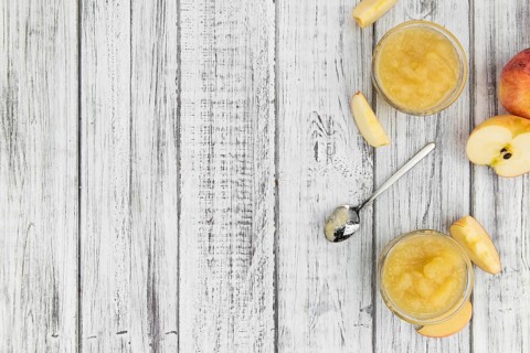 Portion of homemade Applesauce (selective focus, close-up shot) on vintage background