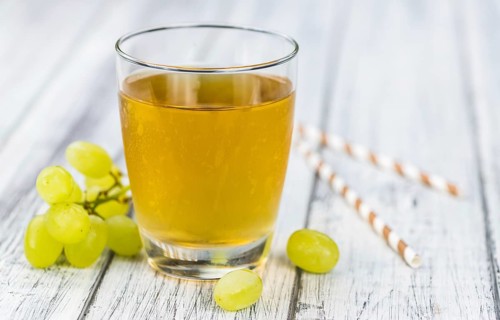 Wooden table with Grape Juice (detailed close-up shot, selective focus)