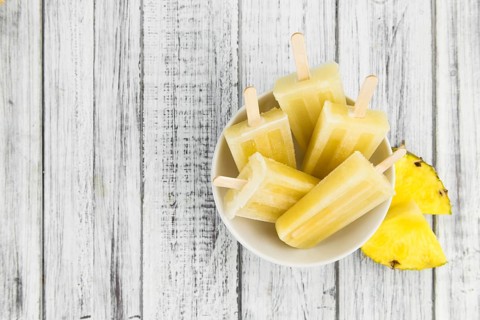 Fresh made Popsicles (Pineapple flavoured, selective focus) on a rustic background