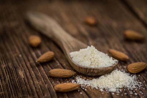 Wooden table with Almond Flour (detailed close-up shot, selective focus)