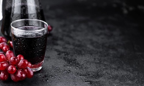 Fresh Red Grape Juice as detailed close-up shot (selective focus)