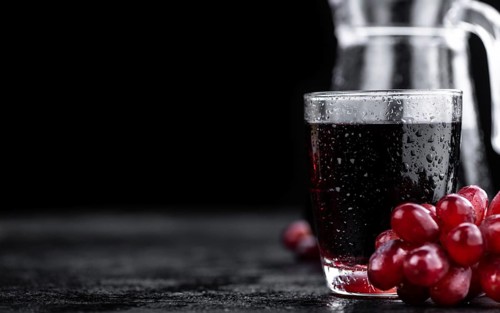 Some fresh Red Grape Juice (selective focus, close-up shot)