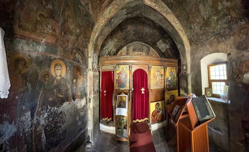 Interior with antique frescoes in the historic small single-nave church Panagia Throniotissa Naos