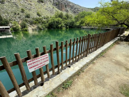 Prohibition sign in Greek and English swimming and fishing is forbidden Swimming and fishing