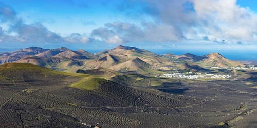 Panorama at sunrise from Montana de Guardilama to the wine-growing region of La Geria, with the