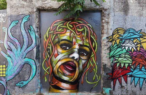 Medusa, female head with hair of colourful snakes, mural in the Anafiotika district, street art,
