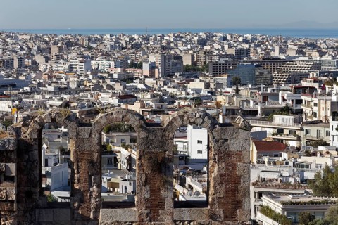 View over the window arch of the Odeon of Herodes Atticus to Athens and the Aegean Sea, Greece,