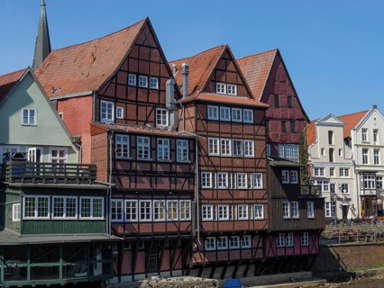 Closely spaced half-timbered houses on a sunny day, bordering the river, lüneburg, germany